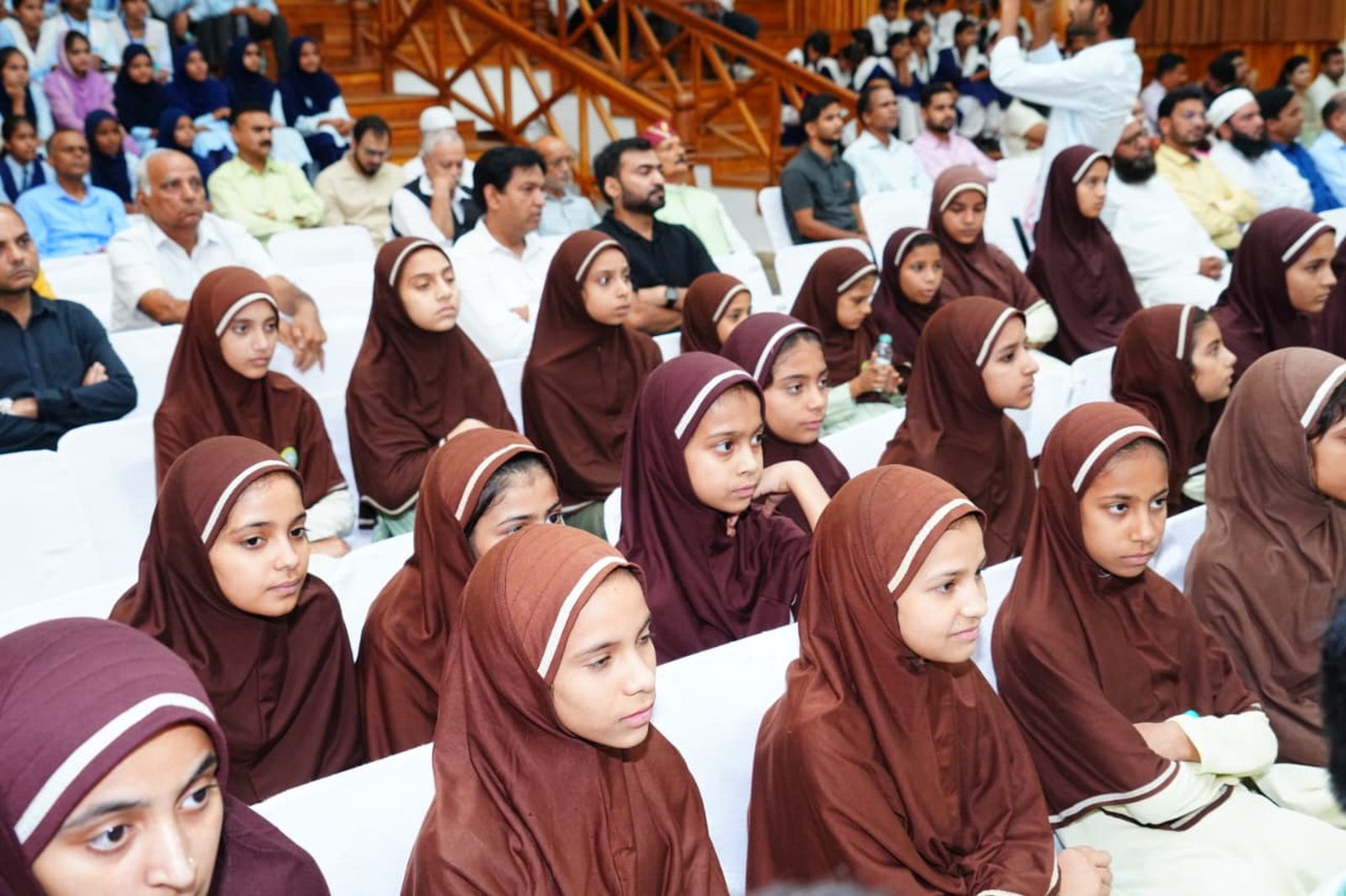AIA students seated in an auditorium audience at a state government event in Dehradun on the new minority education framework. (USAME)